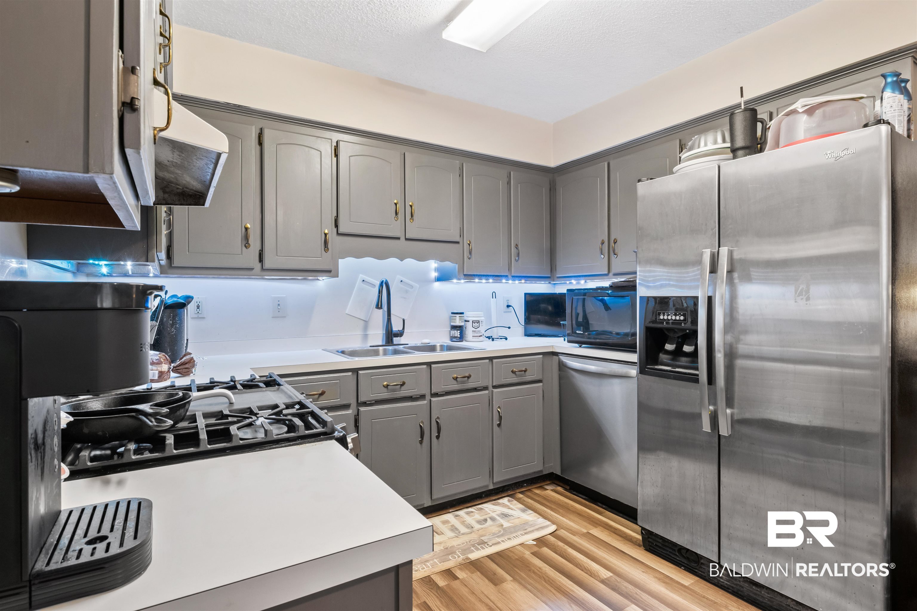 1345 Baker Court Mobile, AL 36695 - Photo 3 of 28 Kitchen with gray cabinets, stainless steel appliances, light hardwood / wood-style flooring, and sink