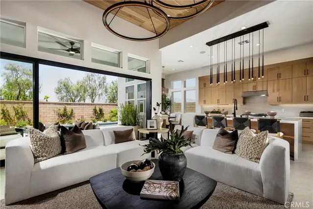 a living room with furniture a rug and a large window