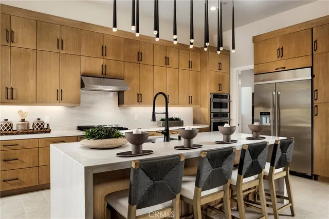a kitchen with appliances a sink and cabinets