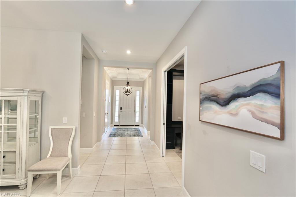 8191 Lucello Terrace North Naples, FL 34114 - Photo 10 of 42 a view of a bedroom with furniture and wooden floor