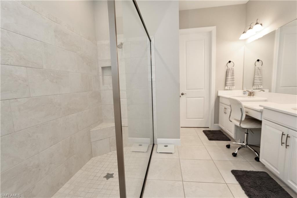 8191 Lucello Terrace North Naples, FL 34114 - Photo 15 of 42 a spacious bathroom with a double vanity sink a mirror and a shower