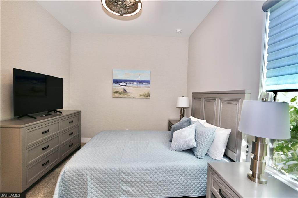 8191 Lucello Terrace North Naples, FL 34114 - Photo 18 of 42 a bedroom with furniture and a flat screen tv