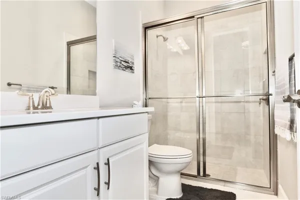 a bathroom with a shower a toilet and a sink