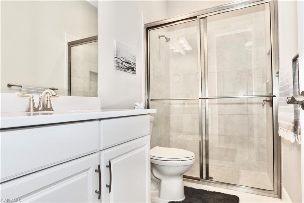 8191 Lucello Terrace North Naples, FL 34114 - Photo 19 of 42 a bathroom with a shower a toilet and a sink