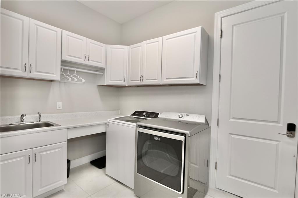 8191 Lucello Terrace North Naples, FL 34114 - Photo 23 of 42 a utility room with sink dryer and washer