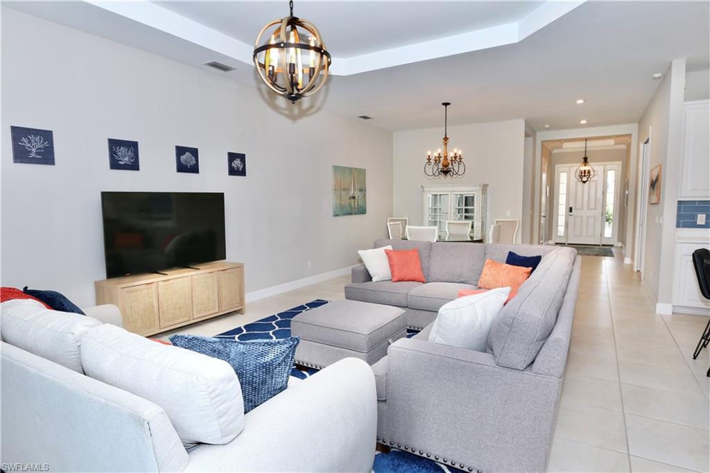 8191 Lucello Terrace North Naples, FL 34114 - Photo 6 of 42 a living room with furniture and a flat screen tv