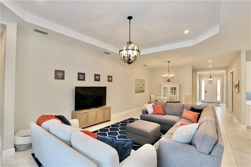 8191 Lucello Terrace North Naples, FL 34114 - Photo 7 of 42 a living room with furniture and a flat screen tv