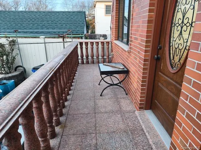 a balcony with wooden floor and furniture