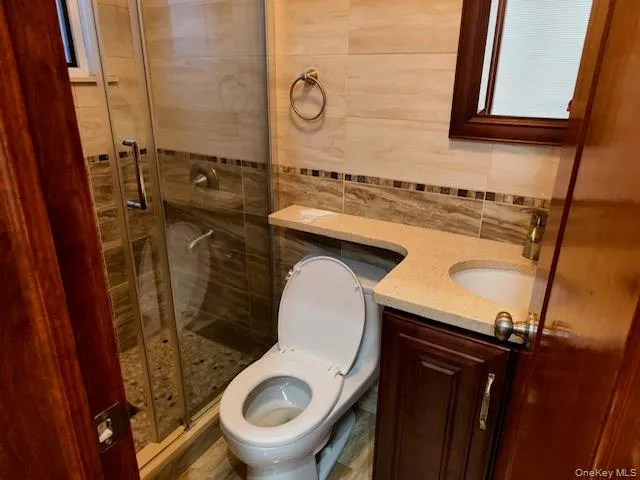 a bathroom with a sink mirror toilet and shower