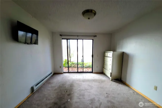 a view of a room with window and a flat screen tv