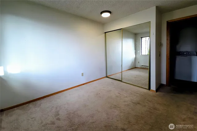 an empty room with closet area