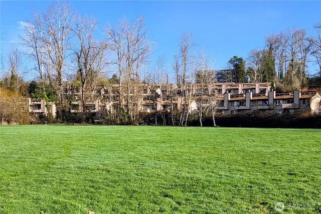 a view of a park with a house in the background