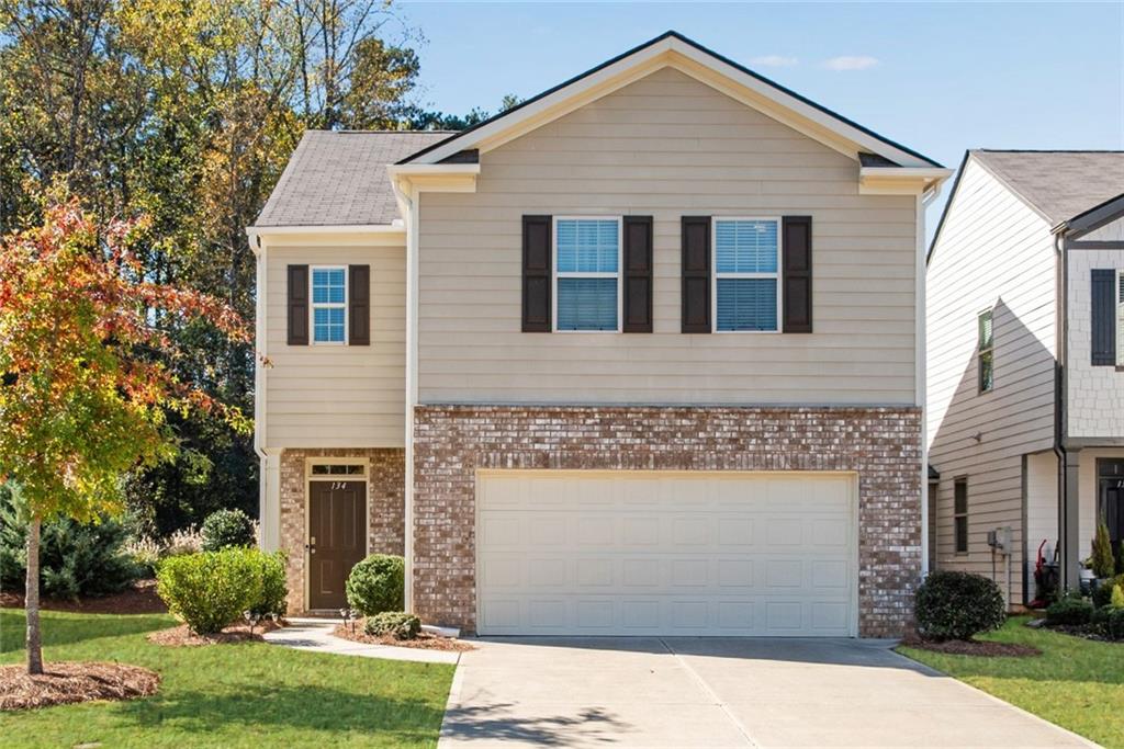 View of front of house with a front lawn and a garage