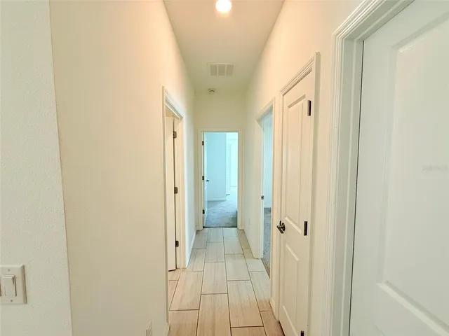 an empty room with ceiling fan and window