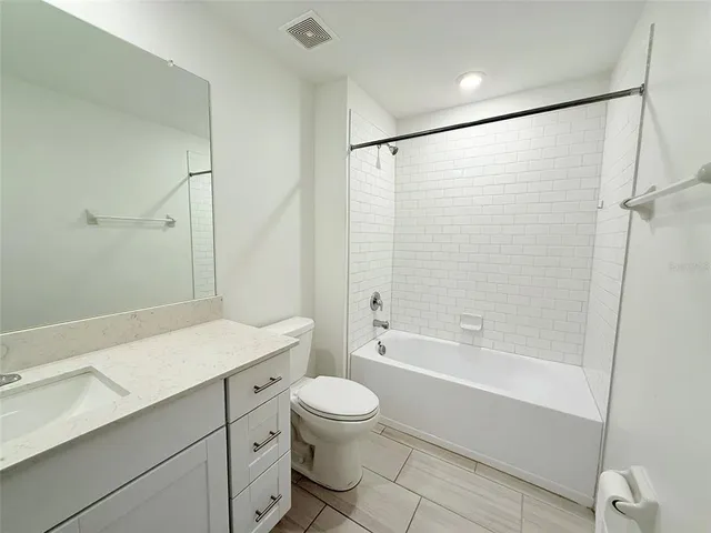 a utility room with cabinets washer and dryer