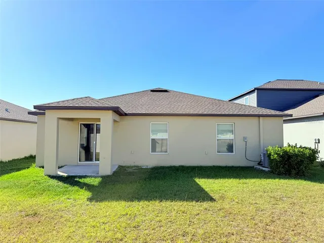 a living room with patio furniture and a floor to ceiling window