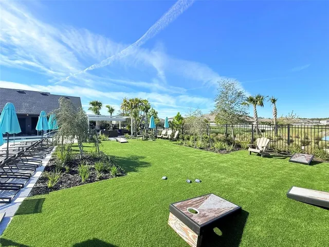 a swimming pool with outdoor seating and yard