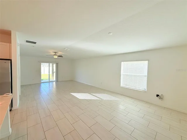 a view of a livingroom with a ceiling fan and window
