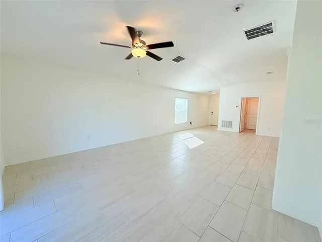 a kitchen with a refrigerator a stove top oven a sink and cabinets