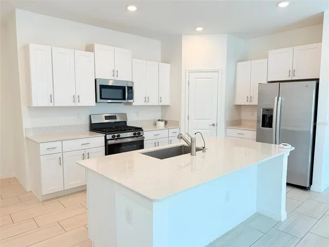 an empty room with a window and a ceiling fan