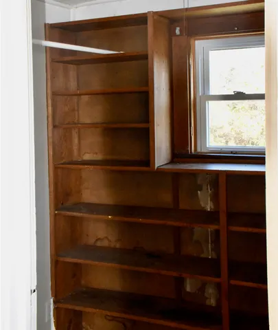 a view of front door with deck and furniture