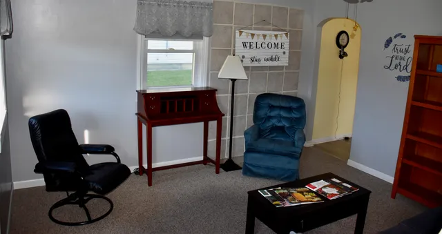 a bedroom with a bed and a painting on the wall