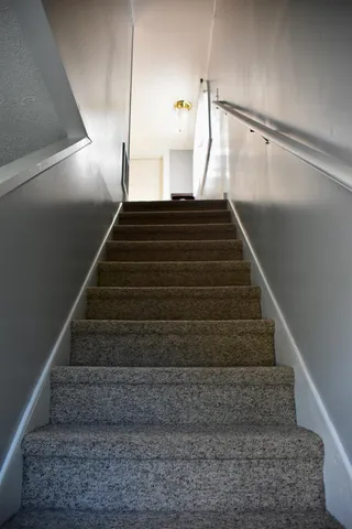 a bed room with a bed and a chair