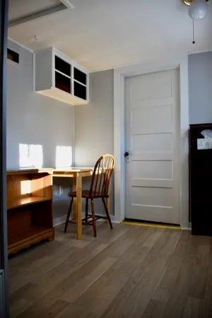 a bedroom with a bed and a painting on the wall