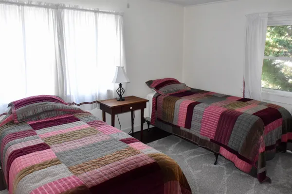 a bed room with a bed and a chair