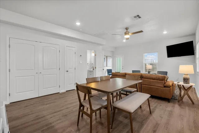 a view of a dining room with furniture and wooden floor
