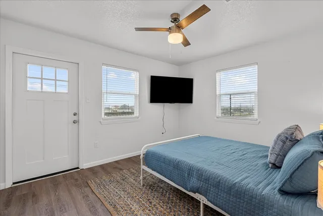 a bedroom with a bed and a flat screen tv