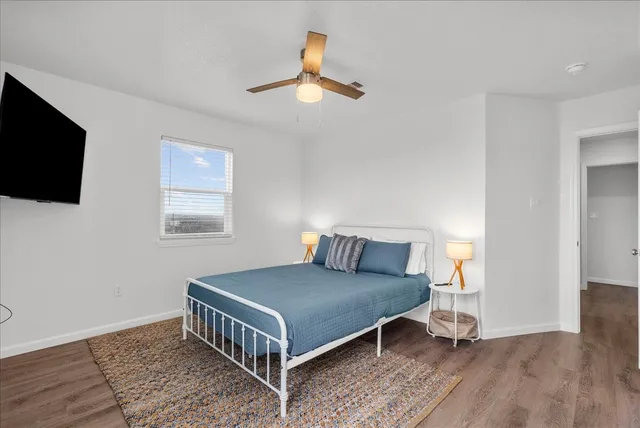 a bedroom with a bed and a flat screen tv