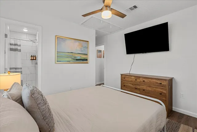 a bedroom with a bed and a flat screen tv