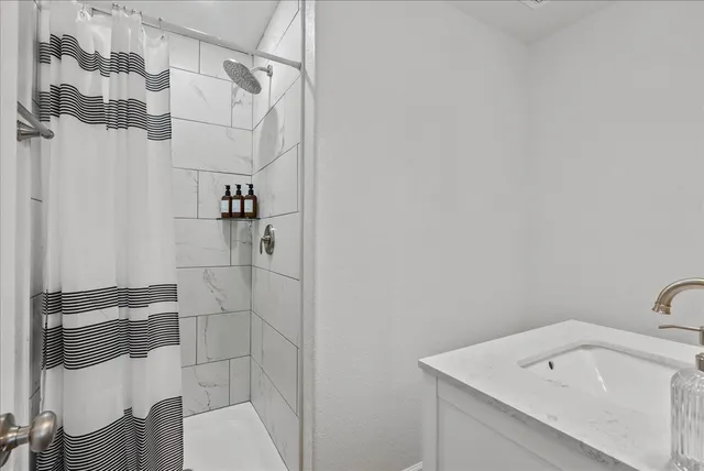 a bathroom with a sink and shower