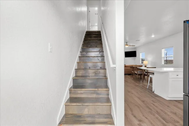 a view of entryway and hall with wooden floor
