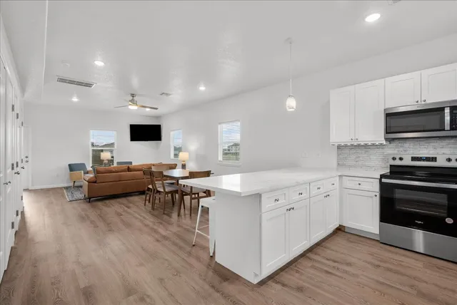 a kitchen with cabinets a sink and appliances
