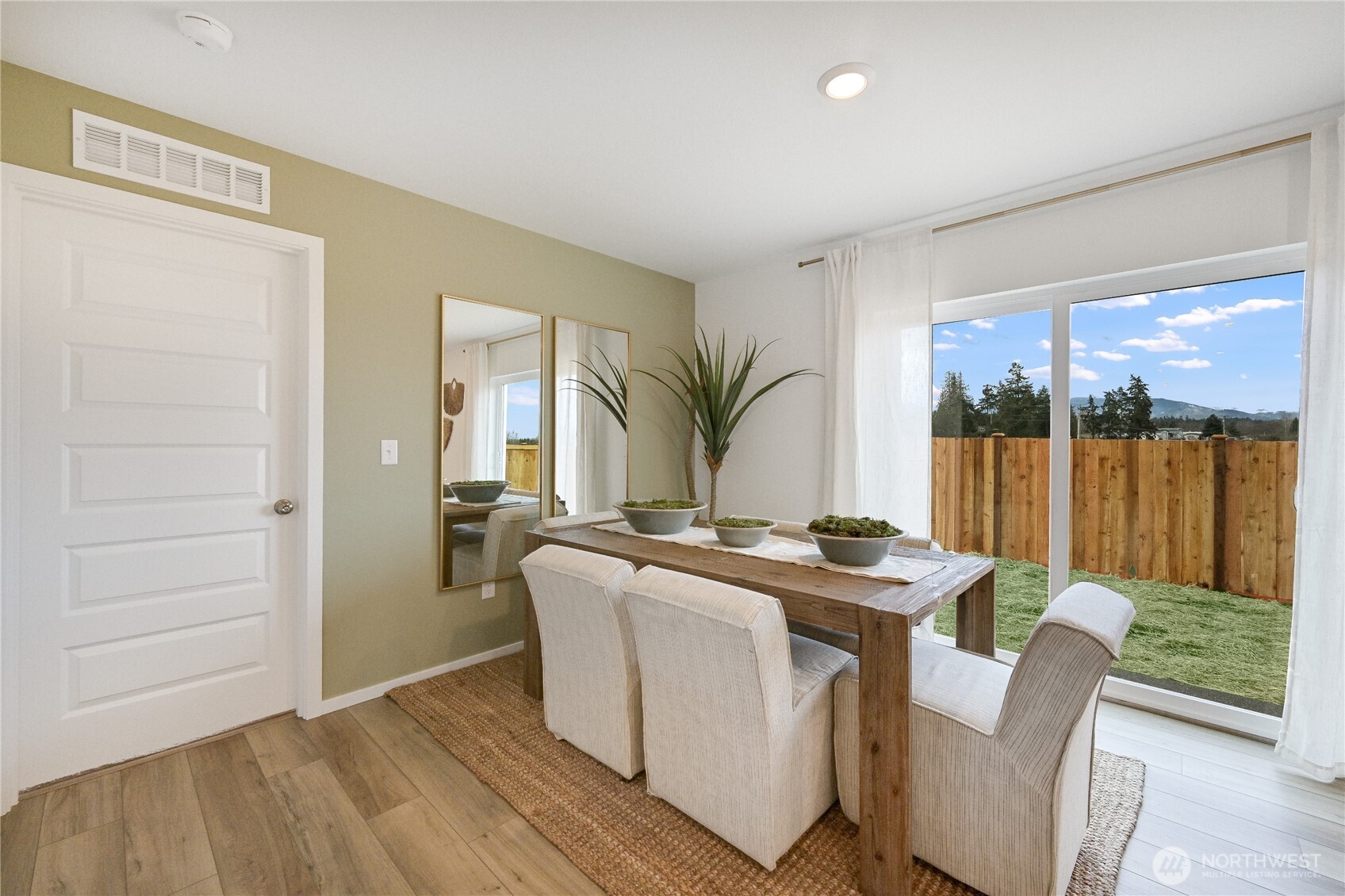 93 Moonshadow Lane Sequim, WA 98382 - Photo 7 of 22 a dining room with furniture a window and wooden floor