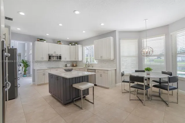 a large kitchen with stainless steel appliances lots of counter top space