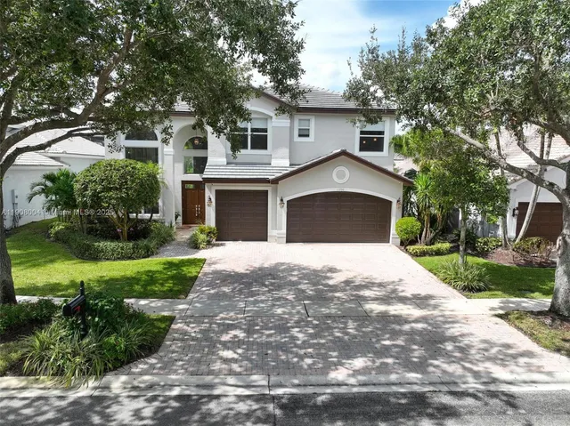an aerial view of city and lake with trees
