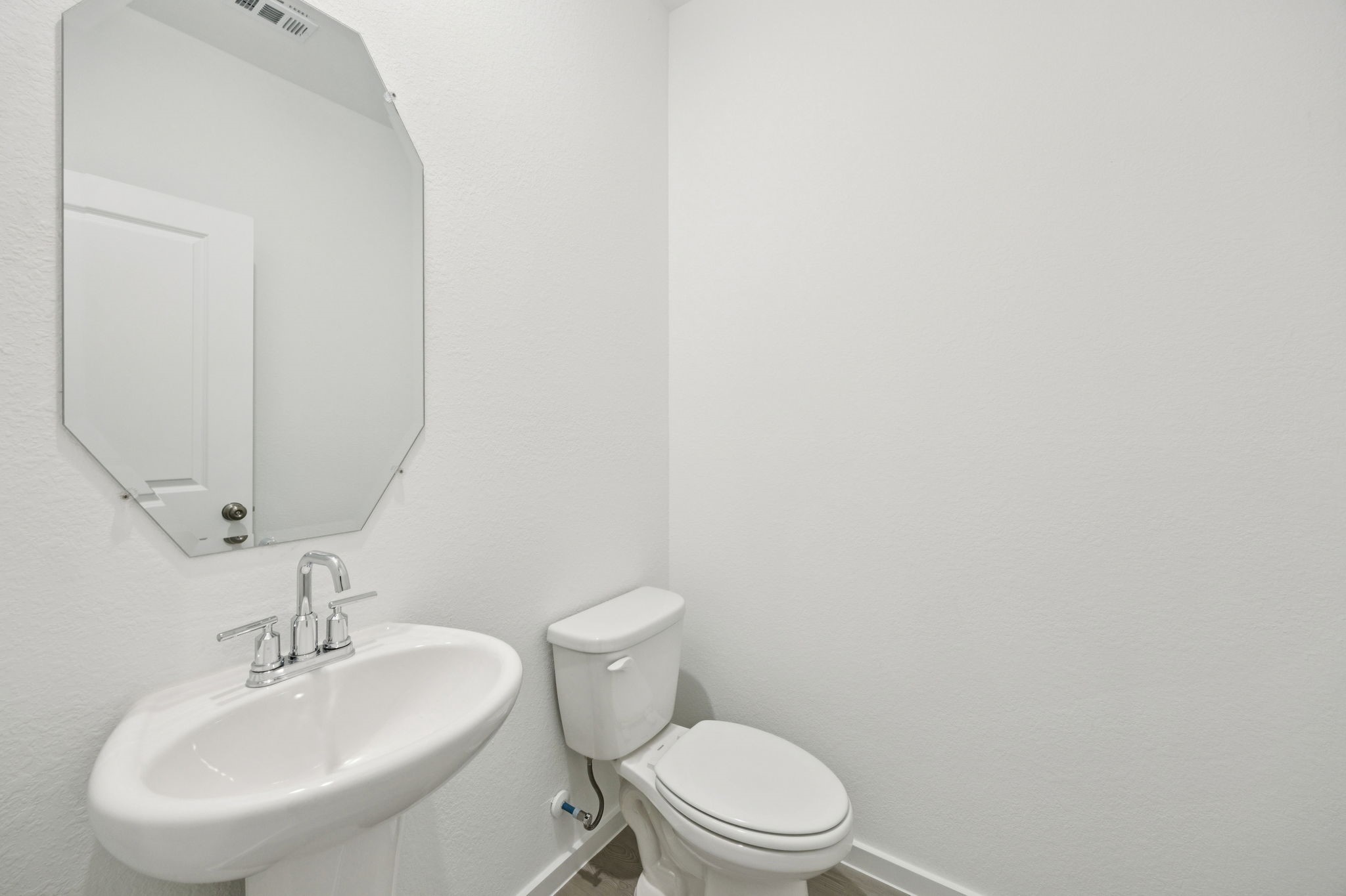 414 Point Nemo Street Crosby, TX 77532 - Photo 17 of 50 a white toilet sitting next to a bathroom sink