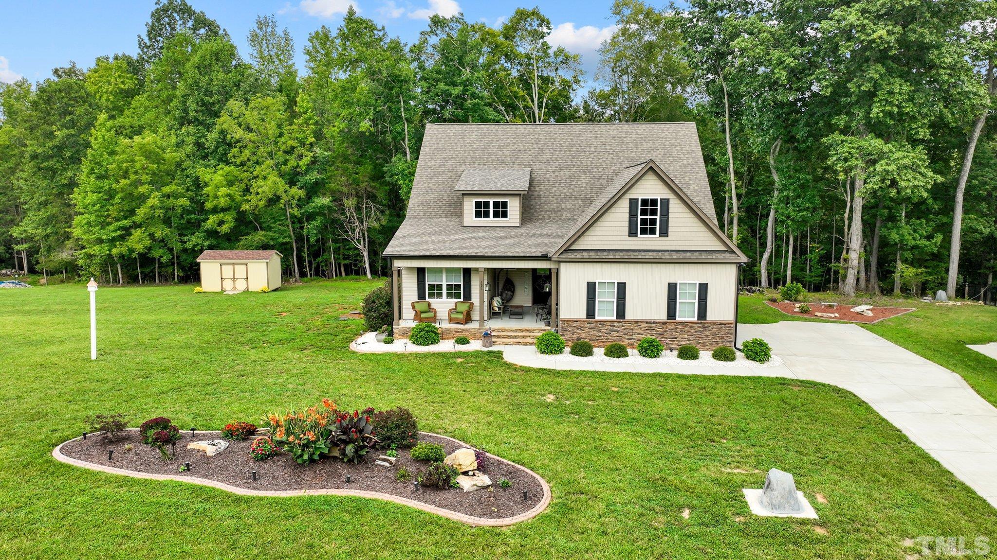 391 River Ridge Lane Timberlake, NC 27583 - Photo 1 of 47 a front view of a house with garden
