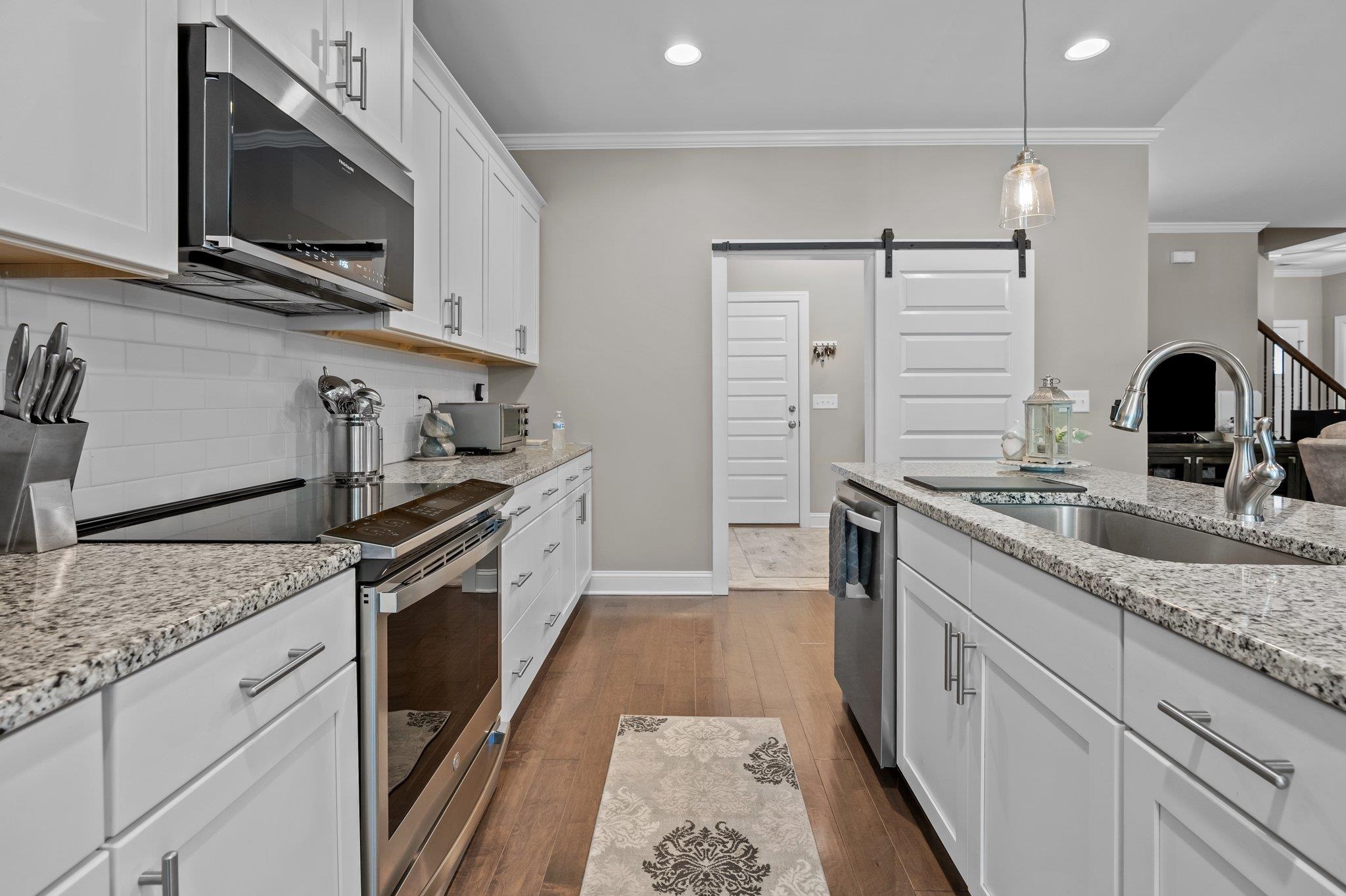 391 River Ridge Lane Timberlake, NC 27583 - Photo 14 of 47 a kitchen with granite countertop a sink and steel appliances
