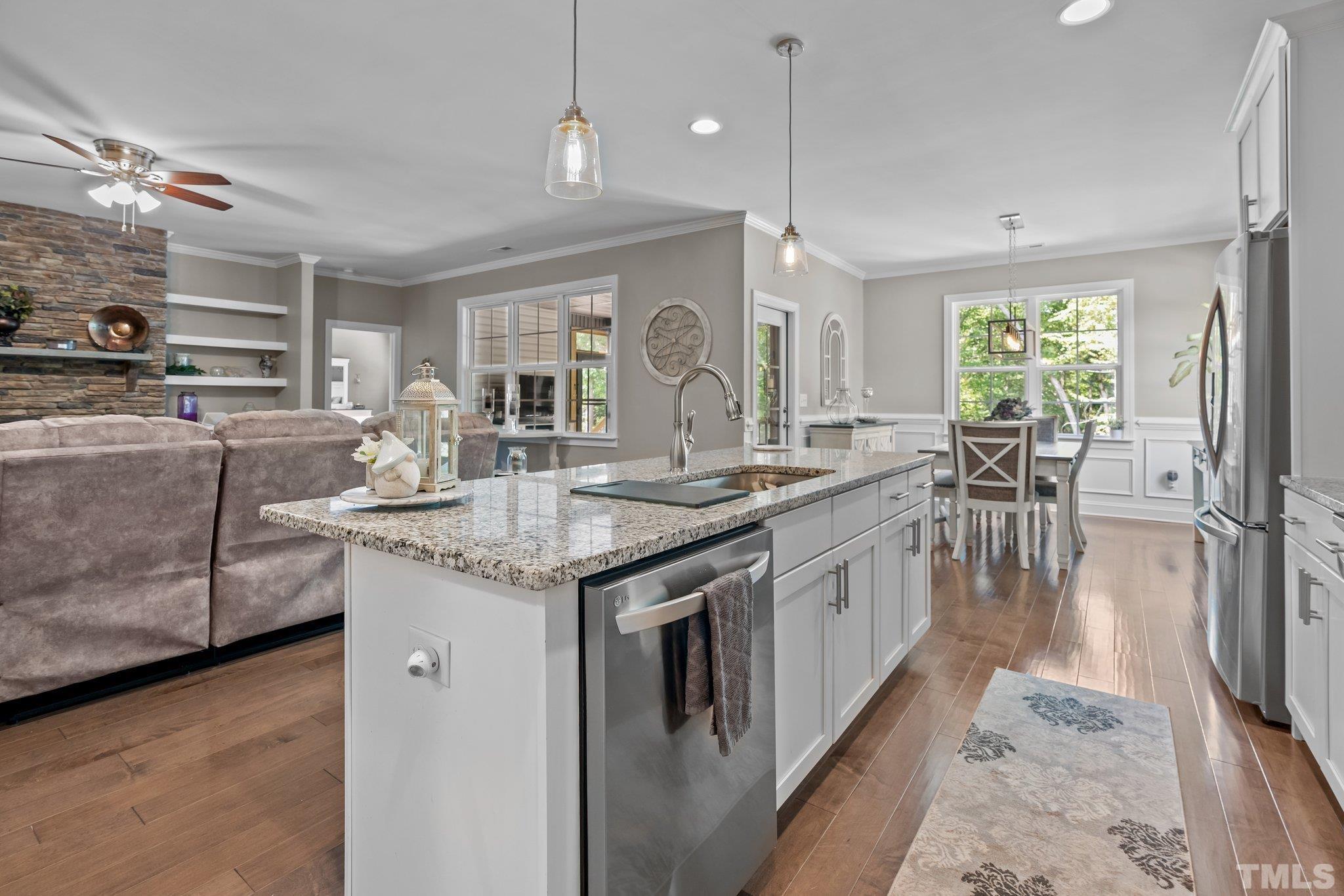 391 River Ridge Lane Timberlake, NC 27583 - Photo 15 of 47 a large kitchen with kitchen island granite countertop a large counter top a sink stainless steel appliances and cabinets