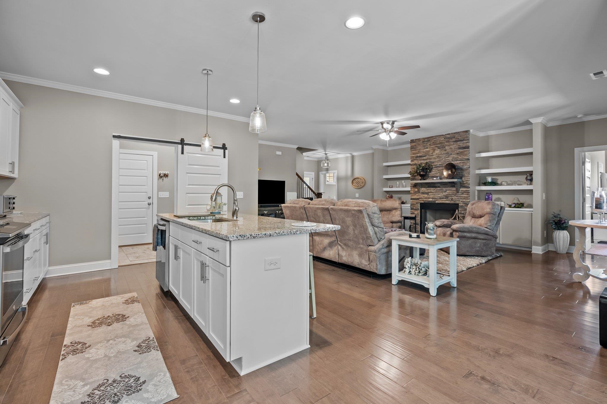 391 River Ridge Lane Timberlake, NC 27583 - Photo 16 of 47 a kitchen with stainless steel appliances kitchen island granite countertop a sink and chairs