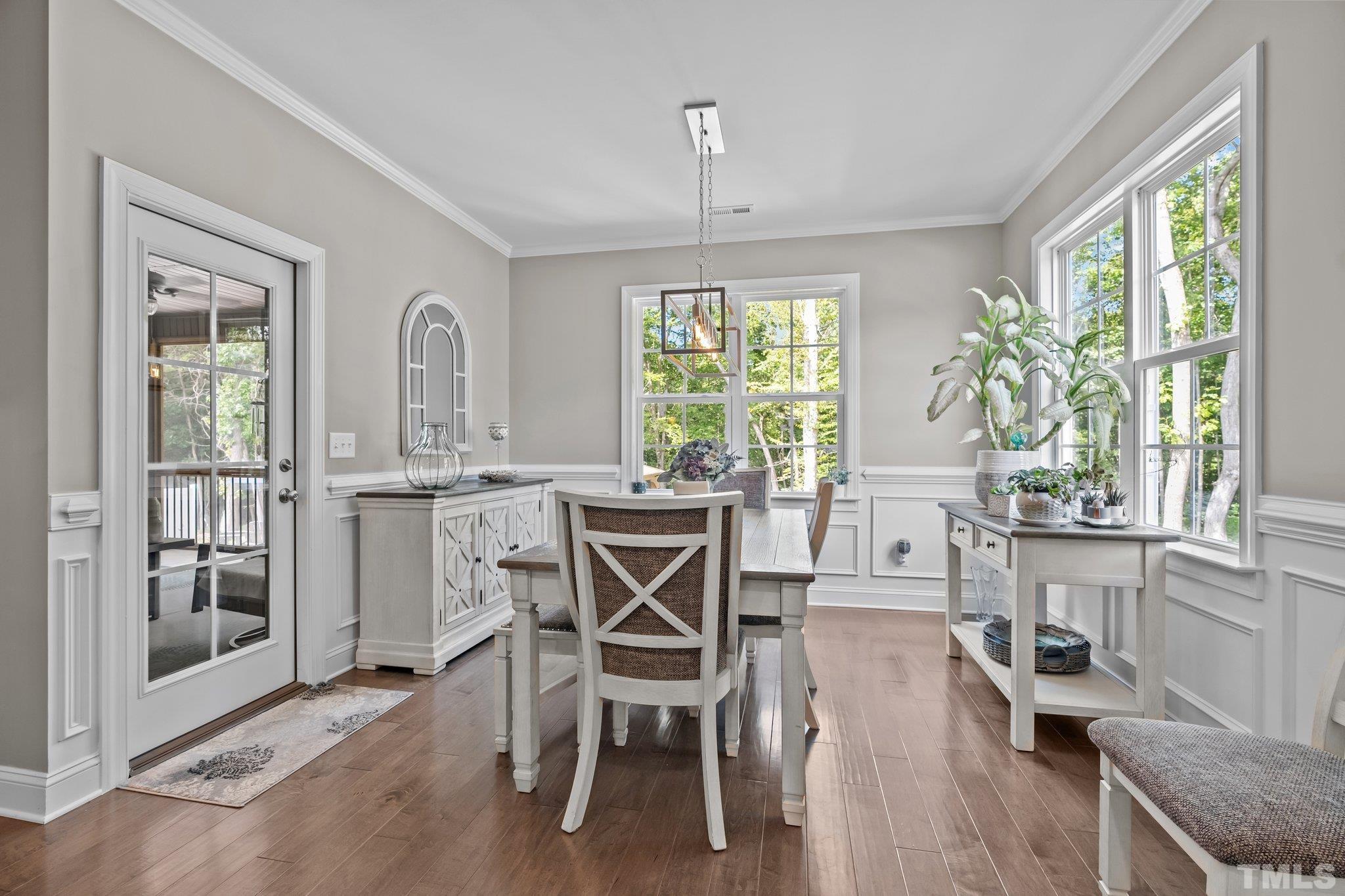 391 River Ridge Lane Timberlake, NC 27583 - Photo 17 of 47 a dining room with furniture a chandelier and wooden floor
