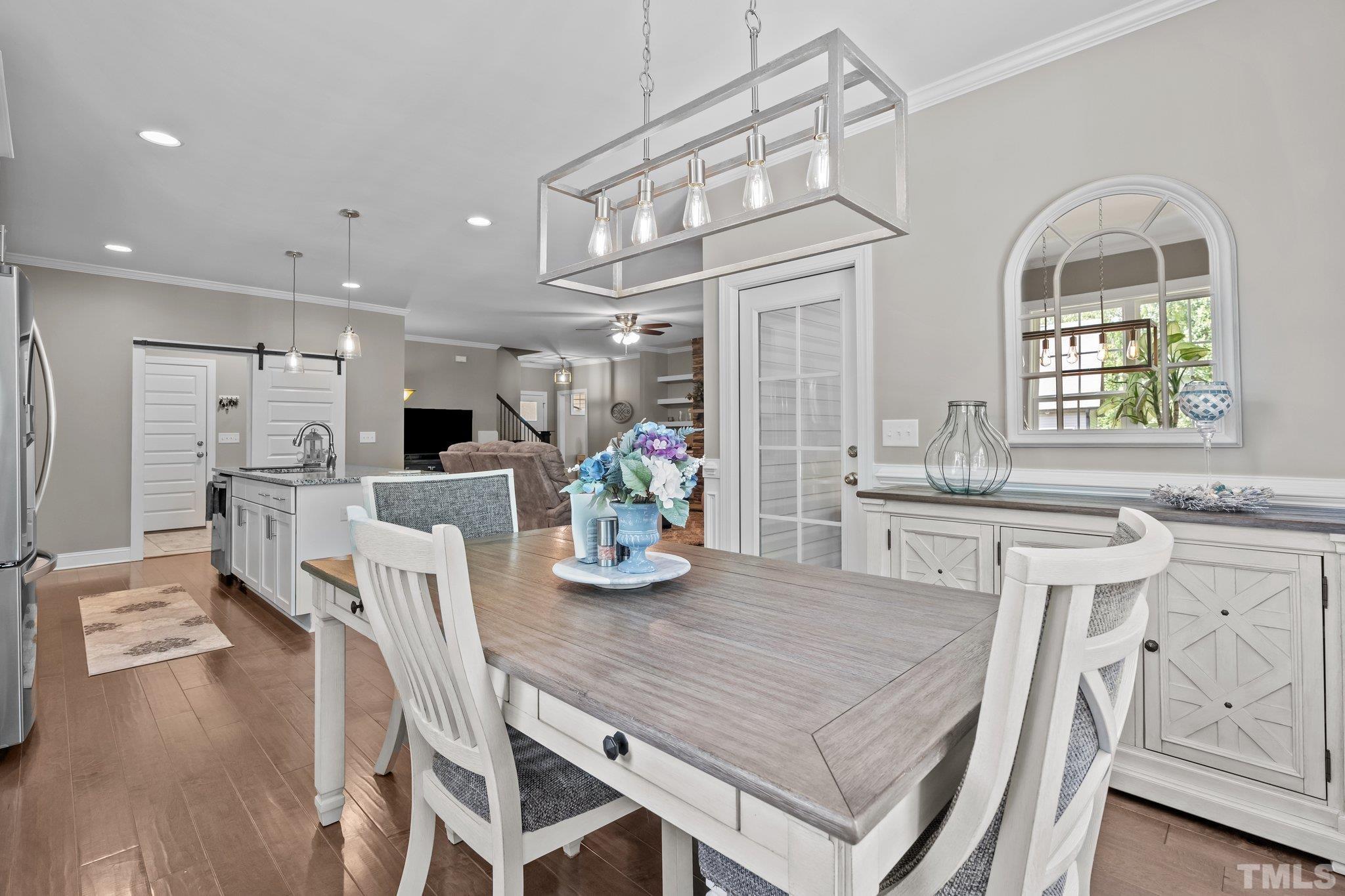 391 River Ridge Lane Timberlake, NC 27583 - Photo 19 of 47 a kitchen with stainless steel appliances granite countertop a dining table chairs and stove