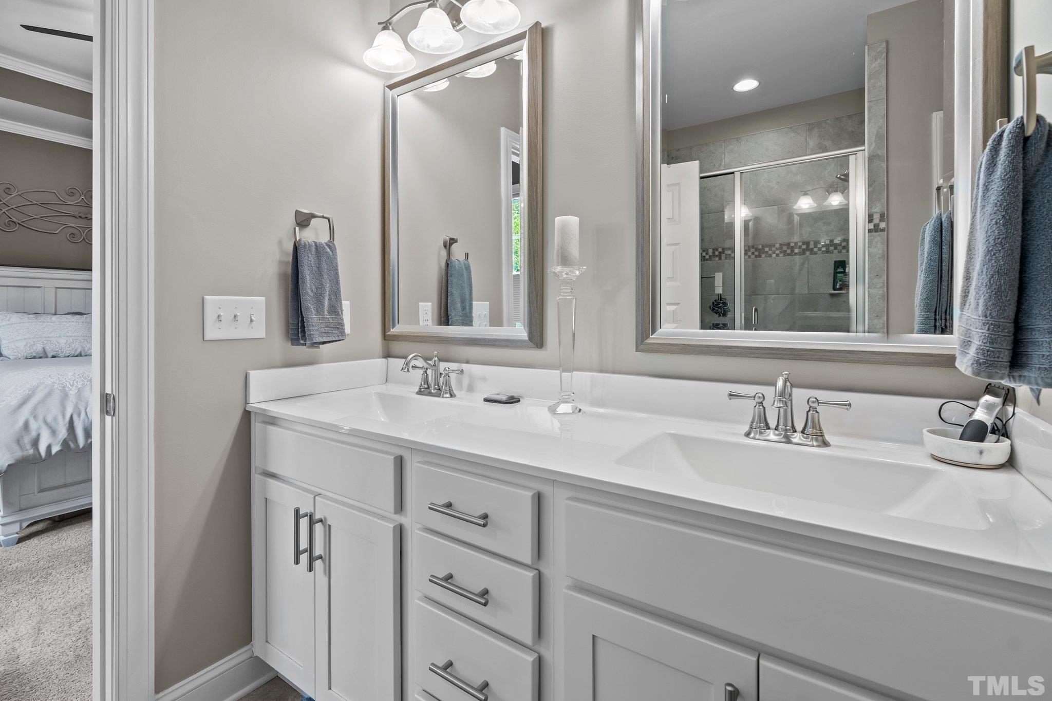 391 River Ridge Lane Timberlake, NC 27583 - Photo 25 of 47 a bathroom with double vanity sink and mirror
