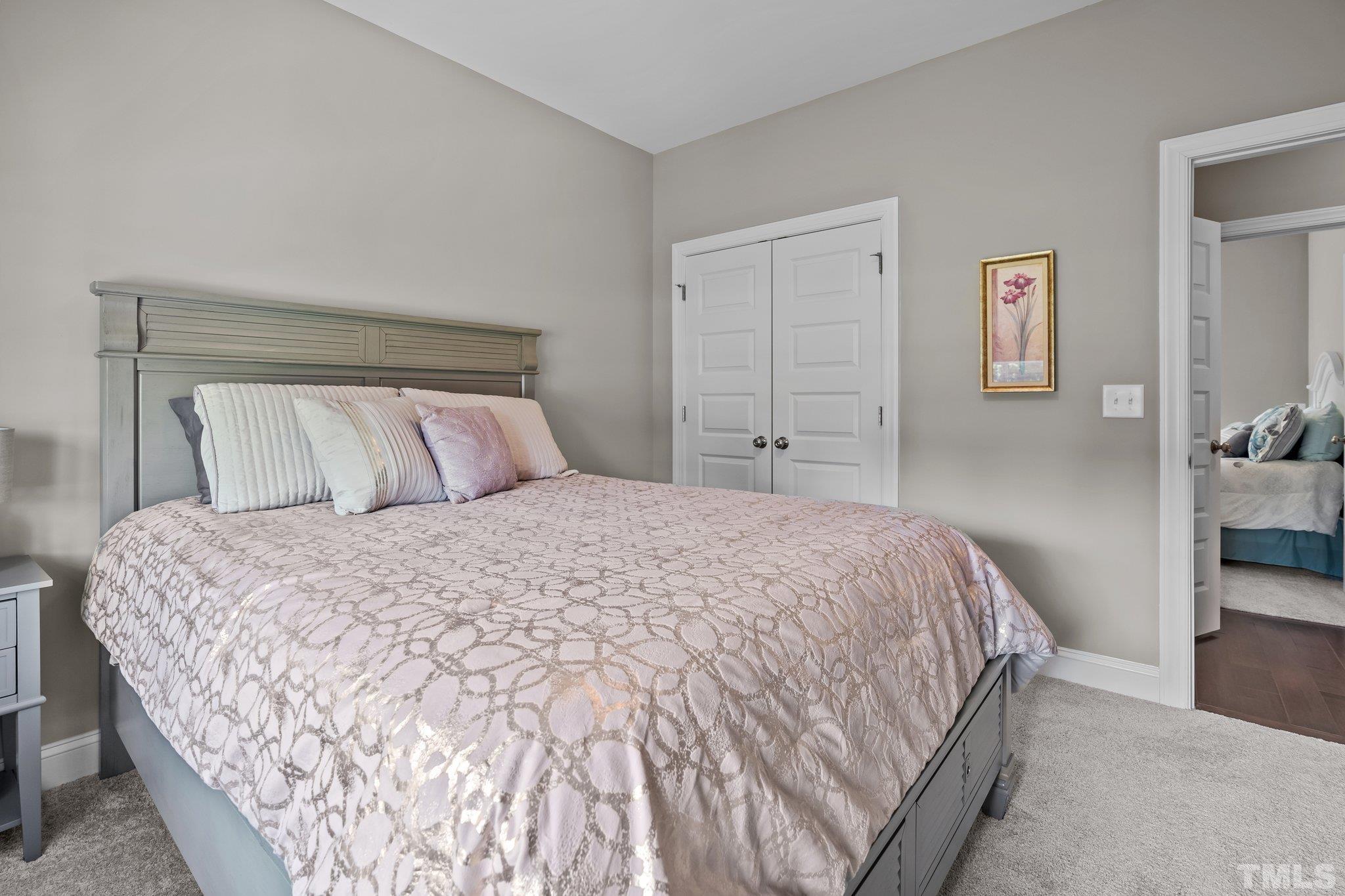 391 River Ridge Lane Timberlake, NC 27583 - Photo 26 of 47 a bedroom with a bed and painting on the wall