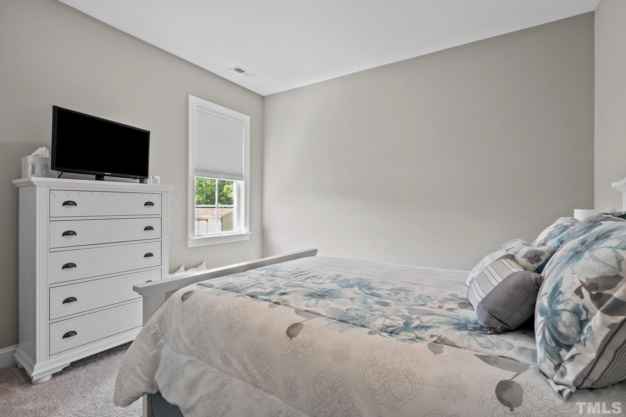 391 River Ridge Lane Timberlake, NC 27583 - Photo 29 of 47 a bedroom with a bed and a television