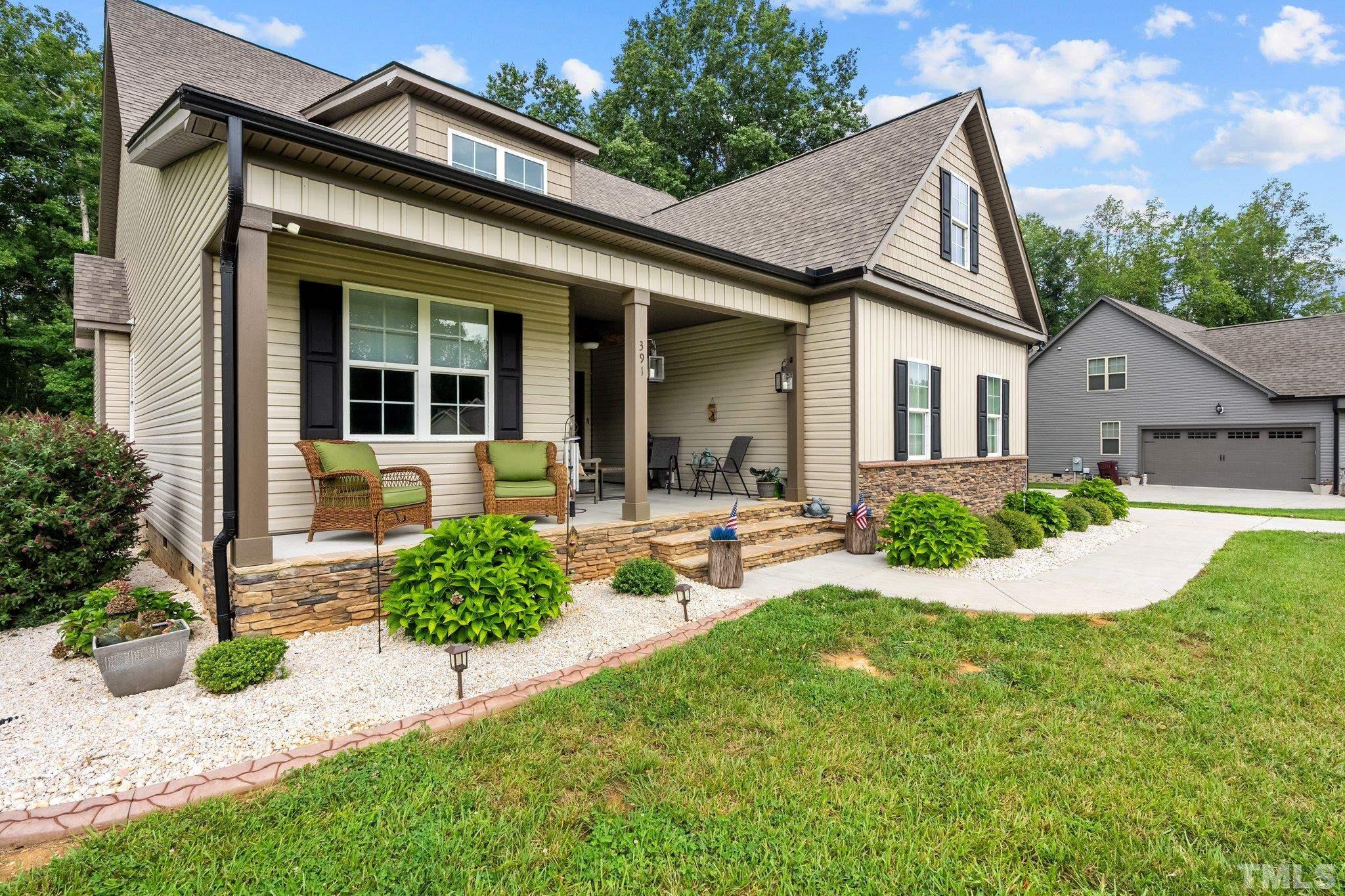 391 River Ridge Lane Timberlake, NC 27583 - Photo 3 of 47 a view of a white house with a small yard and potted plants